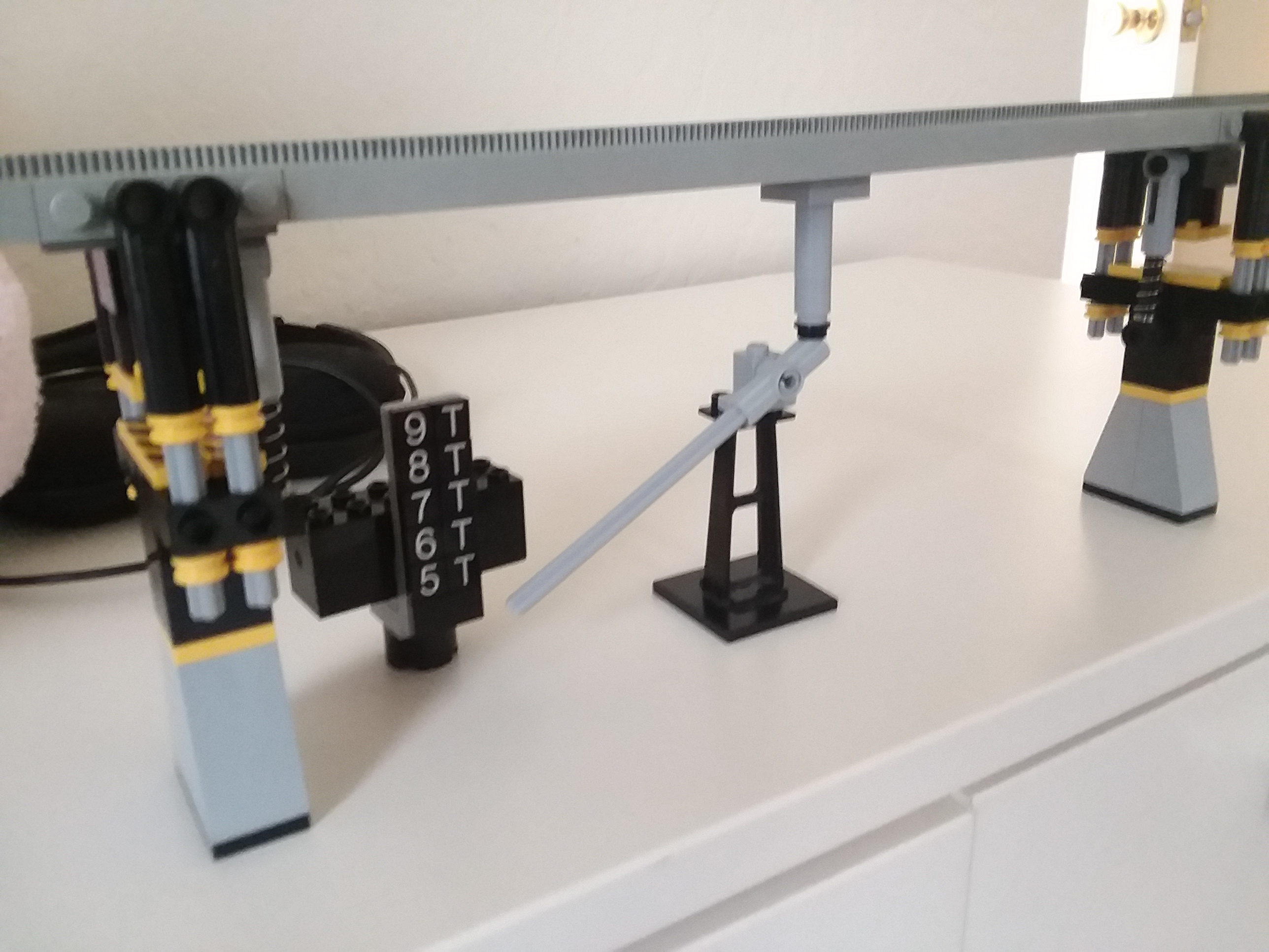 Monorail track scale arm